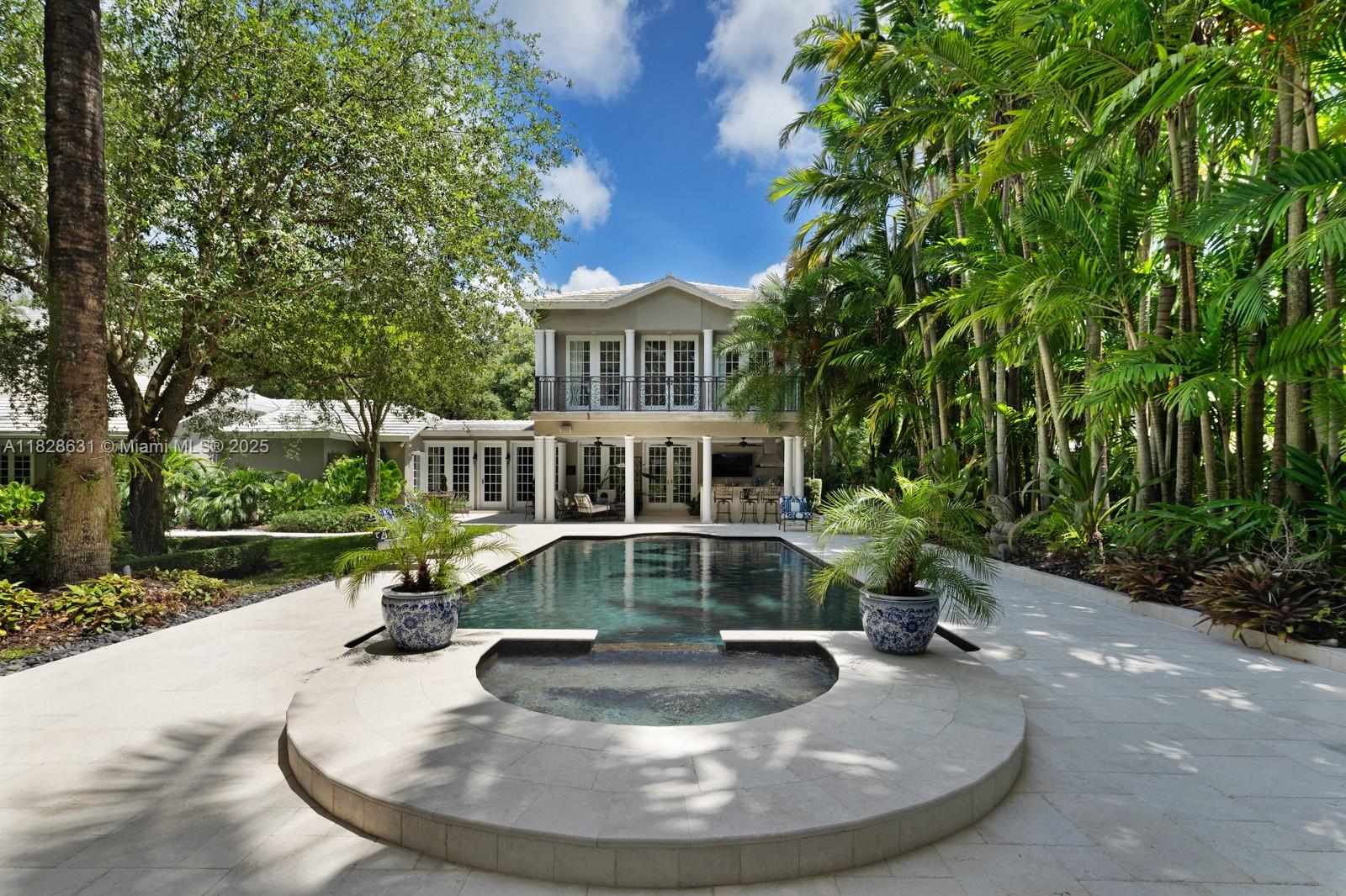 Discover this classic Hamptons-style home now on the market in Palmetto Bay. Ideally located near the Deering Estate, just off Old Cutler Road on a quiet street, and close to top-rated schools, this move-in ready residence sits on a spacious 25,344 square foot lot. The main home features a thoughtful addition, including a separate side residence. Enjoy a summer kitchen, media room, and private gym—perfect for elevated, comfortable living.