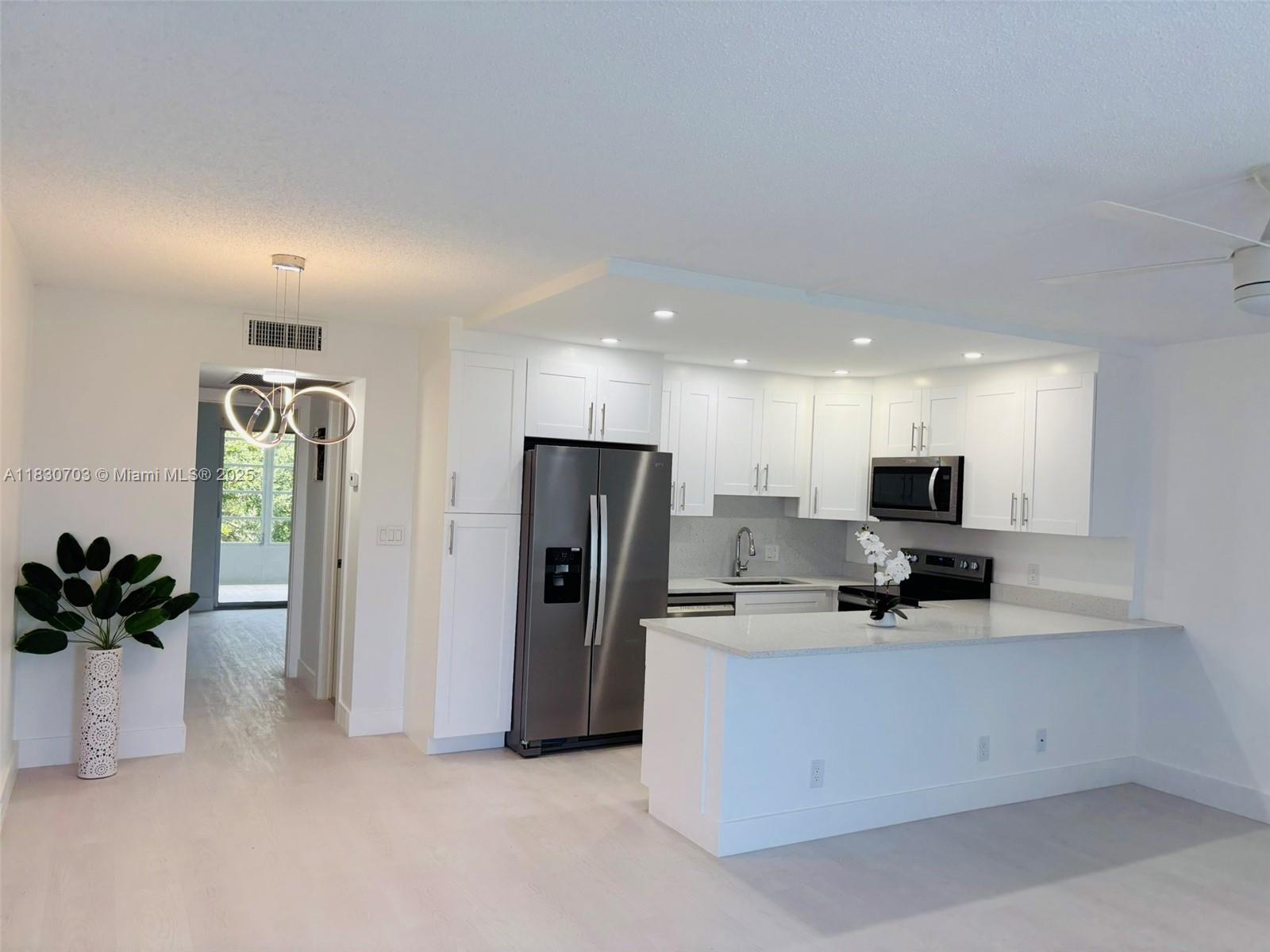 Contemporary design. Completely renovated turnkey beautiful 1 bed 1.5 Baths. Open concept kitchen, ideal for entertaining. Spacious bedrm, Master Bath with shower for convenience. Central A/C. Top of the line appliances. Quartz Counter Tops . Large Florida Rm. Ready to move in. Gated Active 55+ Community with resort Style Amenities, include Theater, Ballroom, Fitness Center, Game rooms, Billiards, Several Art Classes. BBQ area, Pickleball/Tennis Courts, Miniature Golf. Free Shuttle. Great location, across from Shopping and Restaurants. Few minutes to the Beach. Ideal for Seasonal or year round living. All new, just bring your own decor.