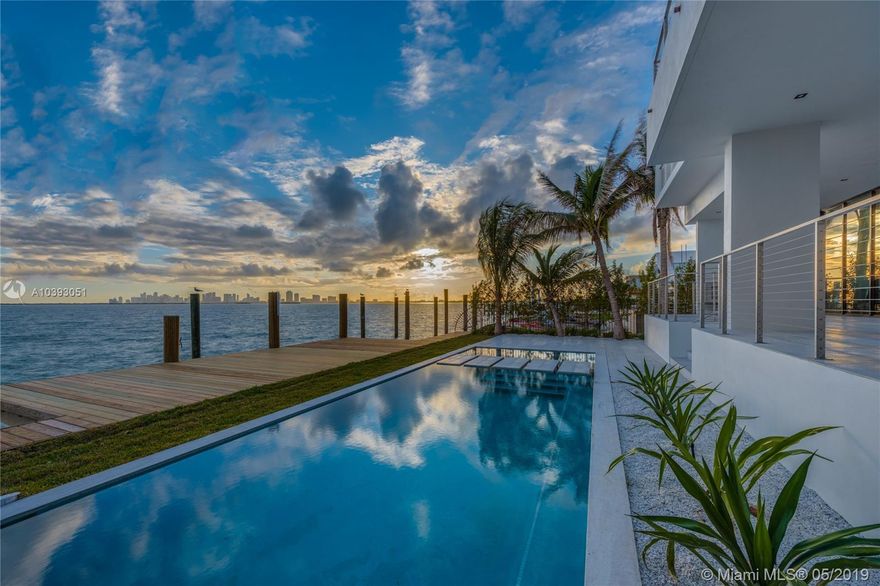 New modern masterpiece offering 60-ft of bayfront & unobstructed views of the Miami skyline! Situated on a 9,000-sf lot, this 6-beds 6+1-baths home welcomes you with a beautiful courtyard leading to a glass-enclosed entry foyer with dramatic double-height floor-to-ceilings glass. The open concept floor plan, wall-to-wall glass doors, & 10-ft ceilings thru-out allow for the maximum exposure of magnificent water views everywhere. Finishes Include: Mia Cucina kitchen, SubZero & Wolf appliances, wood floors, floating stairway, Italian doors. Five beds up, including bayfront master with sitting area, huge terrace, walk-in closet, & luxe bath. Backyard with heated pool, spa, huge covered patio, & summer kitchen. New seawall & dock, 2-car garage, & 2-car carport. Built in 2018 by On One Group.