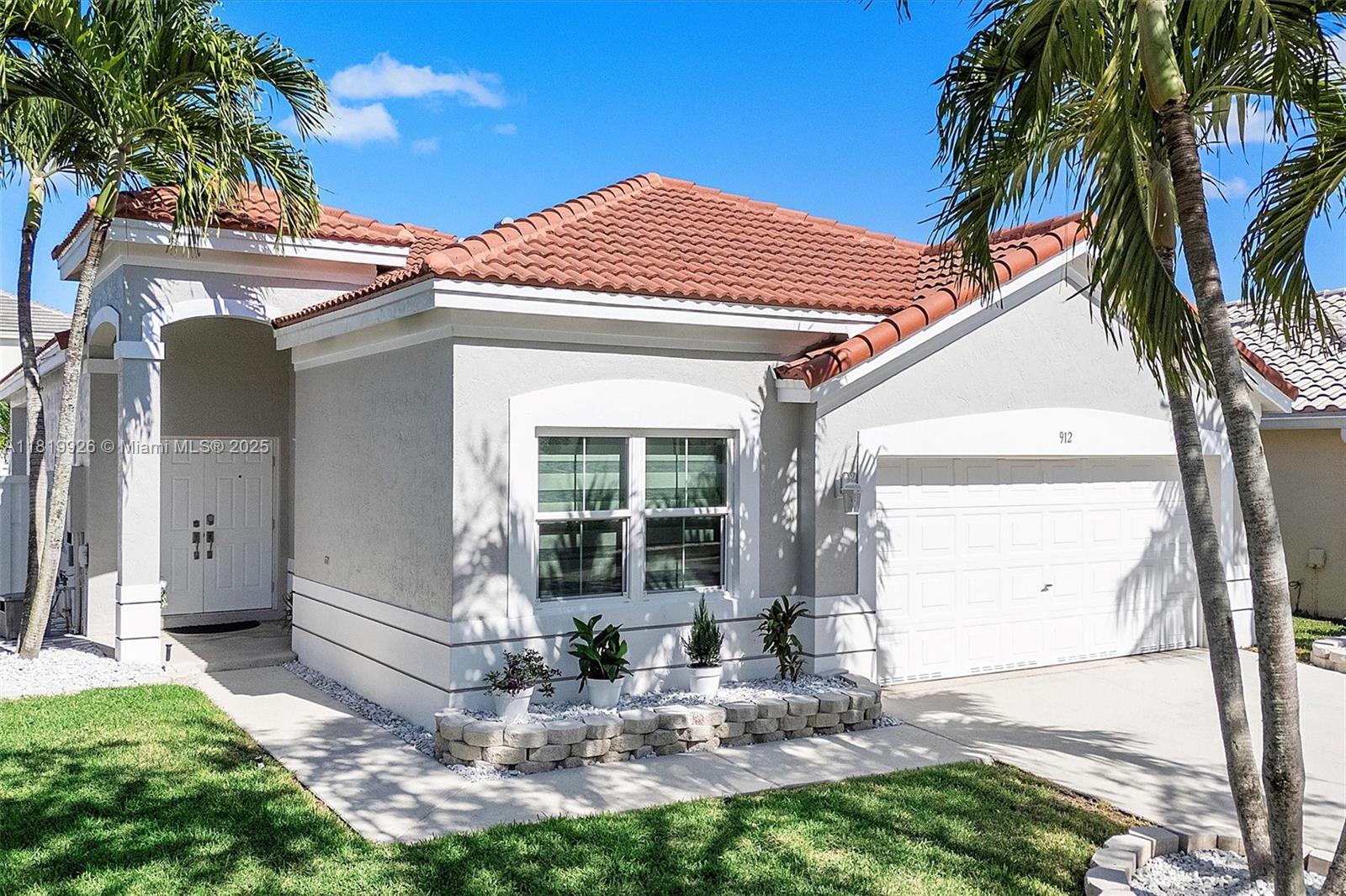 Experience refined living in this beautifully updated 3-bedroom, 2-bath home in The Meadows of Weston. A new roof (2023), brand-new AC (2025) and hurricane impact windows/doors that provide lasting comfort. Inside, enjoy tile flooring, striking light fixtures, modern fans, and breathe taking rear patio. The kitchen shines with stainless steel appliances and flows effortlessly into spacious living areas. Both bathrooms have been completely redesigned with stylish sinks, mirrors, and custom showers. Zebra-style shades add a sleek finish to each room. Make your way outside to a private retreat featuring a covered lanai, stunning paver patio, new fencing, and refreshed tropical landscaping with palm trees—perfect for relaxing or entertaining. Schedule your private tour today.