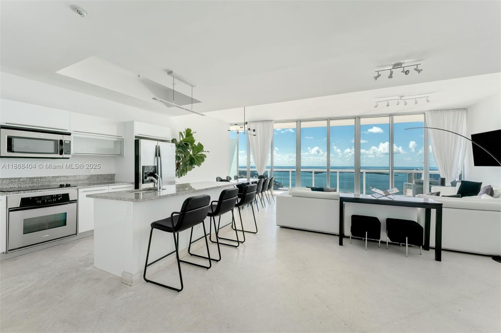Rare opportunity to own the only residence in the building with this one-of-a-kind floorplan—created by combining three units into a spacious two-story home. One of the few two-story units in downtown, with every bedroom offering bay views & balcony access. Perched on the 55th and lower penthouse 56th floor, this 2,663 SF 3 bed / 3.5 bath features two balconies, two living rooms, an open kitchen with natural light, limestone & hardwood floors, motorized shades, and large walk-in closets. Breathtaking panoramic views of the ocean, bay & city skyline fill every room. Includes two parking spaces. Marina Blue offers resort-style amenities: sunrise & sunset pools, hot tubs, fitness & business centers, BBQ, valet, 24/7 security, and more—steps from Kaseya Center, Arsht Center, and museums.