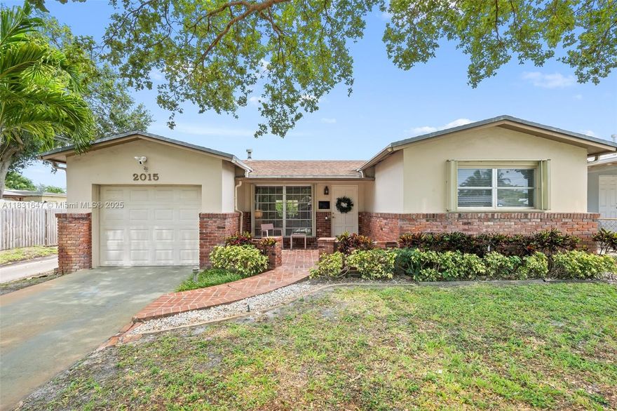 Welcome to this charming and meticulously maintained home at 2015 N 37th Ave in Hollywood Hills! Nestled on a spacious corner lot, this 3 Bed / 2 Bath home offers 1,590 square feet under air and offers a warm and inviting atmosphere. Step inside to discover a great floor plan adorned with updated flooring throughout, making every step feel fresh and new. The heart of the home features an open kitchen that seamlessly flows into the living space, perfect for entertaining or cozy nights in. The backyard is extremely private with lush landscaping surrounding the entire yard and a screened-in covered patio! Prime location in between Fort Lauderdale and Miami and proximate to the beach, major highways, places of worship, the airport and more!