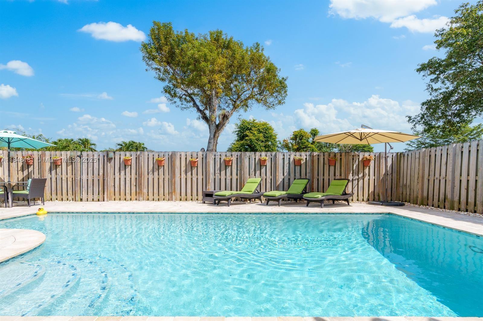 Rare opportunity! This Upgraded gem checks every box- tucked away at the end of a peaceful cul-de-sac in Palm-Aire Village, just steps from a private, fully fenced community park. Enjoy the South Florida lifestyle on the expansive patio with elegant marble pavers, a pristine pool and shade from mature trees. Features include a 2021 roof, 2016 A/C, electric roll down screened patio, and accordion hurricane shutters throughout. Super low HOA- No Approval needed. Quick access to Turnpike, a bike ride to the Inter Miami stadium, and Just minutes to the beach.