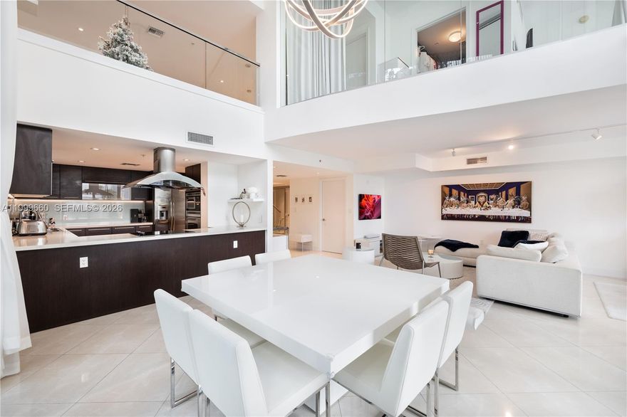 A rare offering at Eloquence on the Bay, this two-story waterfront residence delivers the privacy and scale of a single-family home within a discreet condominium setting. With only one shared wall, the home lives quietly and independently, an uncommon quality along the waterfront.

Interiors open to a private backyard and expansive patio, creating a seamless connection to the outdoors just moments from the water’s edge. Positioned alongside the pool and near the marina, a boat slip is available for purchase, allowing for effortless access to open water.

Thoughtfully arranged across two levels, the residence offers a calm, understated approach to coastal living designed for those who value privacy, simplicity, and quiet sophistication.