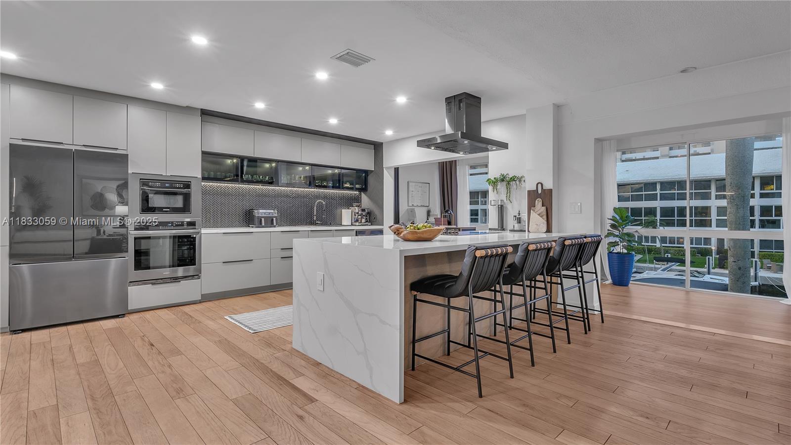 Experience luxury living in this beautifully remodeled 2-bedroom, 2-bathroom condo with breathtaking water views! Every detail has been thoughtfully designed, featuring a chef’s kitchen with an expansive island, quartz countertops, and top-of-the-line appliances—perfect for entertaining. The open-concept layout is flooded with natural light through large windows, creating a bright and airy ambiance. Both bathrooms have been exquisitely remodeled with high-end finishes. Enjoy peace of mind with a new roof assessment already paid by the seller. Boat lovers rejoice! A dock is available for rent, accommodating boats up to 45 feet. Located just minutes from restaurants, bars, shopping, and within walking distance to the beach.