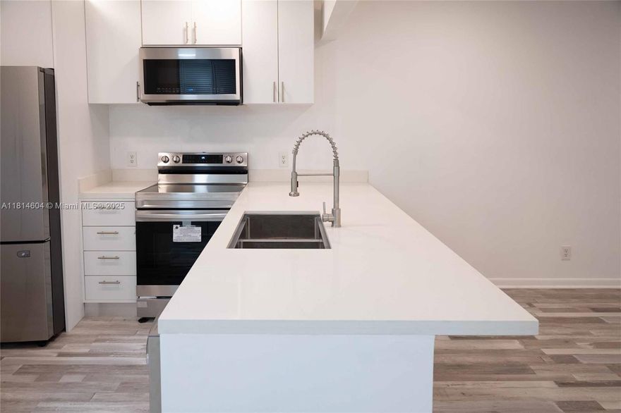 Step into effortless living with this turnkey, designer-furnished 2-bedroom, 2-bath condo in the highly sought-after 55+ community of Oriole Gardens III. Fully renovated and never lived in since—just pack your suitcase and move in! The sleek open kitchen showcases quartz countertops, soft-close shaker cabinets, subway tile backsplash, and a full set of stainless steel appliances. Beautiful laminate wood flooring adds warmth throughout the unit.
The spacious primary suite includes a large walk-in closet, and both bathrooms have been upgraded with modern finishes. Enjoy your morning coffee or evening wine on the newly tiled patio with peaceful garden views.