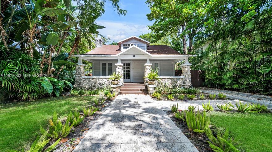Beautifully remodeled 1920s Miami bungalow located in the heart of Buena Vista, a historic and highly sought-after neighborhood just steps from the Design District. This detached single-family home blends timeless charm with modern updates, featuring original refinished hardwood floors, elegant archways, and a statement fireplace. A light-filled kitchen with custom cabinetry and brass lighting flows to a private tropical deck surrounded by lush landscaping. The home offers three bedrooms plus a finished attic—ideal for an office, yoga loft, or guest retreat. Enjoy gated off-street parking and expansion potential on a 5,750 sq ft interior lot. A rare opportunity to own a character-filled residence minutes from Wynwood, Midtown, and Biscayne Bay