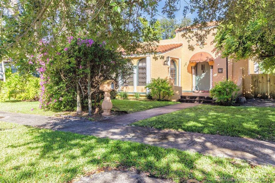 Designated historic, featured on HGTV, lovely Spanish mission architecture nestled in the shade of huge oak tree. Lush gardens and roomy backyard. Main house is a 2/2 with a rear cottage w/a 1/1 efficiency. Mexican tile with inlays & wood floors, updated kitchen w/gorgeous granite counters and stainless appliances. Fireplace, new roof, accordion shutters, brand new decks & fence, walk ins and recessed lighting.  A must see!!