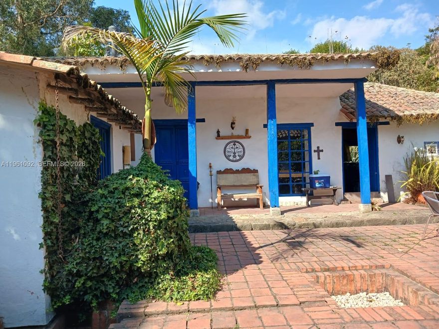 Discover a unique opportunity to own a recreational farm in Tenjo, Cundinamarca, just 45 minutes from Bogotá. Perfect for weekend escapes, agricultural projects, or a peaceful retreat surrounded by nature. Set on a generous 7,200 m² lot, this charming property blends traditional architecture, productive potential, & versatile living spaces. The Main House is a 150 m² Spanish-style residence with a cozy fireplace, a beautiful central patio that fills the home with natural light, & classic architectural details that create warmth & character. The inviting layout is ideal for family gatherings, entertaining guests, or simply enjoying the tranquility of the countryside. Additional structures include a two-story 20 m² office with a glass-enclosed second floor, perfect for remote work, creative projects, or private study with inspiring rural views. There is also a 25 m² studio 1/1, ideal for guests, a caretaker, rental income, or independent living space. With agricultural & investment potential, the existing hydroponic system can be activated and put into production, offering an excellent opportunity for sustainable agriculture, specialty crop cultivation, agrotourism, or farm operations. Surrounded by fresh mountain air & green landscapes, this farm offers privacy, space, & accessibility. Whether you envision a recreational retreat, a productive agricultural venture, or a countryside lifestyle with modern work-from-home flexibility, this property delivers exceptional versatility.