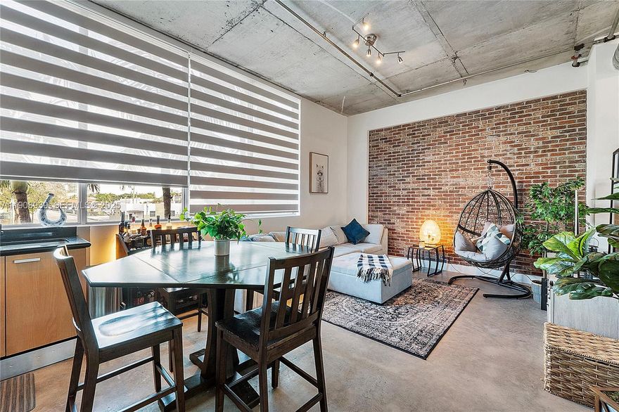 NY-Style! Modern Loft Residence with Private Terrace, just 1 Mile from Hollywood Beach. Rare 2 BR/1.5 BA (1,182 SF). Featuring soaring ceilings, polished concrete floors, exposed-brick wall & open kitchen with stainless-steel appliances. Huge private terrace + direct street access lives like a townhome. Impact windows/doors, interior washer/dryer, 1 assigned covered space (option for second). HOA $1,085/mo. Annual and seasonal rentals OK from day one. ESA pets ok. Minutes to Downtown Hollywood, walk to Young Circle, Cafés & Restaurants. Seller motivated will pay assessment OR closing-cost credit with full-price offer. Bring offers!  Only 1 available out of 5 of this unique style loft in the building. Short term rentals allowed. Live the Downtown-Meets-Beach lifestyle. Shown by appointment