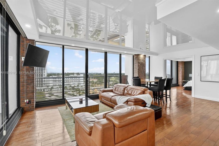 Exceptional value in this Light-filled and inviting, this stylish 14th-floor one-bedroom residence in Home Tower Condos features dramatic floor-to-ceiling Hurricane Impact Windows showcasing expansive city and skyline views with sweeping southeast and west exposures stretching from Hollywood Circle to the ocean. The open-concept layout offers seamless flow between the living, dining, and kitchen areas, enhanced by rich wood flooring and exposed brick accents that add warmth and character. Sliding glass doors open to a private balcony, extending the living space and maximizing indoor–outdoor enjoyment. Modern upgrades provide a clean, contemporary feel, while the well-maintained, established building offers exceptional value at nearly half the cost of surrounding new construction, creating strong upside potential. Enjoy a highly walkable lifestyle with restaurants, cafés, nightlife, shopping, parks, and the beach all just minutes away. Washer and dryer included. A standout opportunity where location, views, and value align in one of Hollywood’s most desirable urban settings.