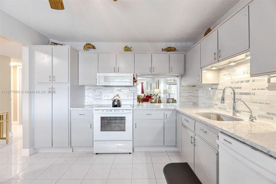 Reduced for a quick sale!! Largest 2/2 condo in the community, with over 40k in upgrades, don't miss this well-maintained waterfront beauty. Recent upgrades include impact windows and patio door, remodeled bathrooms, new kitchen cabinets and countertops, new water heater, high-efficiency AC, updated flooring, and modern lighting. This fully furnished home features an extended living room, generously sized bedrooms with walk-in closets, and your own laundry and storage room with a full-size washer and dryer, totaling 1,350 square feet under air!  Enjoy the serene water view! The complex has undergone all major renovations and successfully completed its 40-year condo recertification with no pending assessments. The active clubhouse offers a pool, tennis, pickleball, gym, pool tables, a game room, library, and sauna.