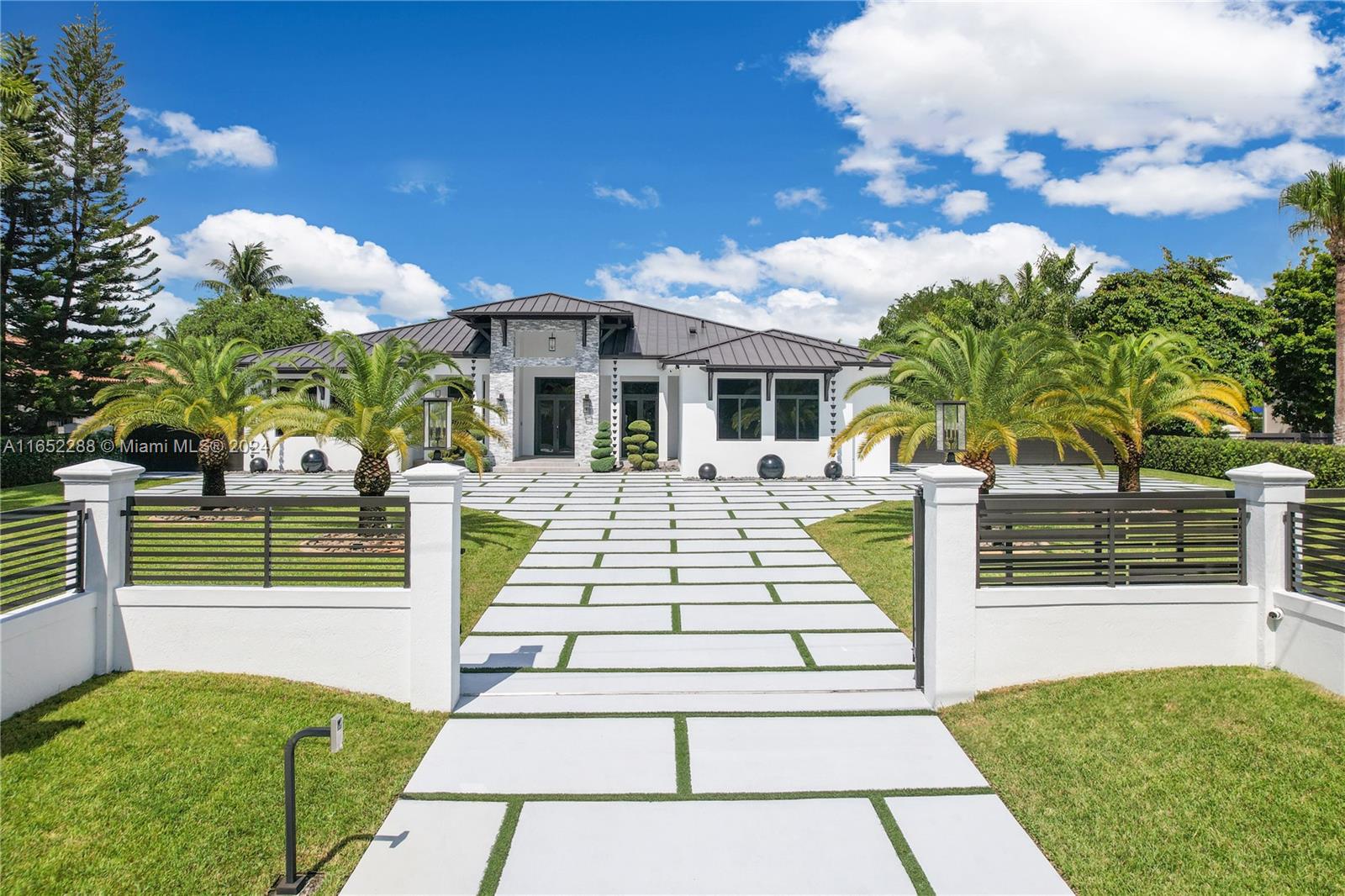 This stunning 2022 estate spans 5,841 sq. ft. on a 40,249 sq. ft. lot, featuring 6 bedrooms and 6 bathrooms. Upgrades by the owner, a general contractor, include a permitted guest house, modern outdoor kitchen, and exquisite landscaping .The property boasts solid construction, smart and security systems, hurricane-resistant windows, doors, glass railings, and an aluminum fence with automated gates. The main house includes a gym/double garage, high ceilings, modern finishes, and a luxurious master suite. The 600 sq. ft. guest house offers privacy. Located on a private street in a prestigious area, this home is minutes from Dolphin Mall, Miami International Airport, and Miami Beach.