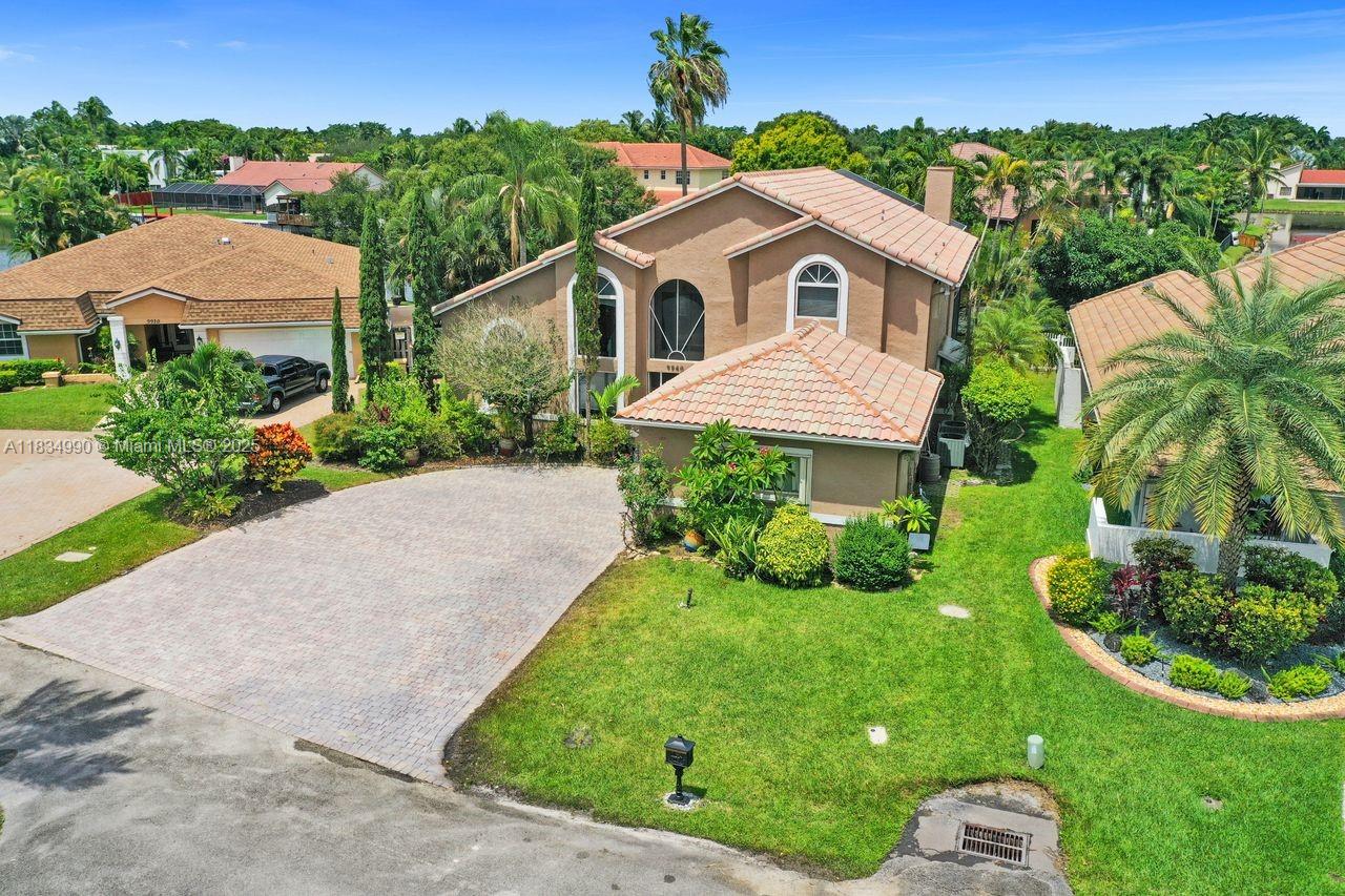 Tucked away on a quiet cul-de-sac in Jacaranda Cove, this stunning waterfront home offers a total of 3700 sq ft of elegant living on an expansive 11,200 sq ft lot. Featuring 5 bedrooms and 4.5 baths, including two spacious en suite master suites—one upstairs and one downstairs—this layout is ideal for multigenerational living. Enjoy soaring ceilings, abundant natural light, and open living areas. The main-level master opens to a screened patio with a 25-ft pool and waterfall. Highlights include some impact windows, accordion shutters, a newer A/C (2019), a loft, and an open and spacious kitchen with a granite island…Discover this rare gem before it's gone…