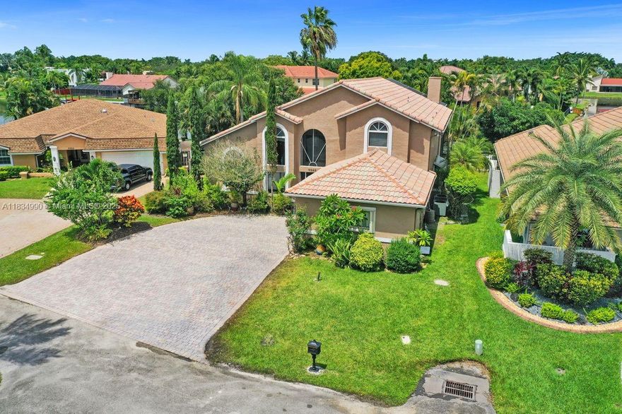 Tucked away on a quiet cul-de-sac in Jacaranda Cove, this stunning waterfront home offers a total of 3700 sq ft of elegant living on an expansive 11,200 sq ft lot. Featuring 5 bedrooms and 4.5 baths, including two spacious en suite master suites—one upstairs and one downstairs—this layout is ideal for multigenerational living. Enjoy soaring ceilings, abundant natural light, and open living areas. The main-level master opens to a screened patio with a 25-ft pool and waterfall. Highlights include some impact windows, accordion shutters, a newer A/C (2019), a loft, and an open and spacious kitchen with a granite island…Discover this rare gem before it's gone…