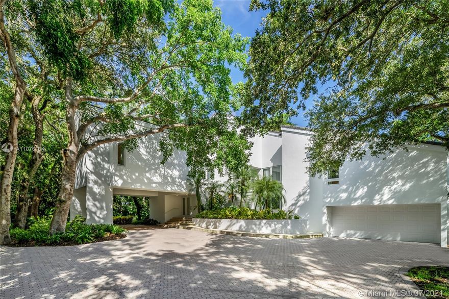 A contemporary 5,297 sq ft house sits on an impressive 1.4 acres filled with lush gardens and large oak trees. This bright, freshly-painted and spacious home offers high ceilings, impact windows and doors throughout with 5 bedrooms and 6.5 bathrooms. The perfect split plan with all bedrooms located on the 2nd floor. The two large decks and large, beautiful pool make this house the perfect home for entertaining. Roof is 2015. Home is part of the Gables Estates Club and membership approval is a pre-requisite to purchase.