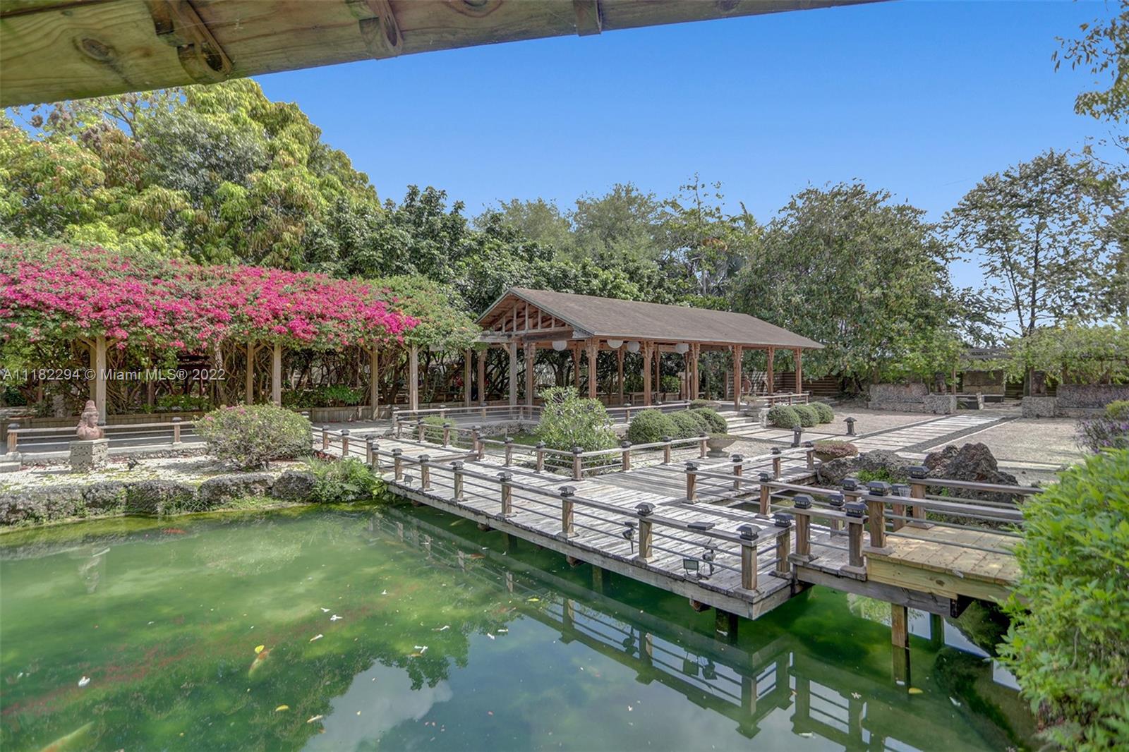 2.5 Acre Redlands Koi Gardens is one of the most unique and well known properties in South Florida. A beautiful property with endless income opportunities. The main home boasts over 4,000 sqft of living area. Step out to your backyard and enjoy your private tropical oasis, with freeform pool, full bar and various sitting areas. Property also includes a fully operational Asian inspired indoor/outdoor event venue for up to 150 guests with private bathrooms and caterer’s prep area, fully operational koi farm, legal airbnb cottage, meditation building, large multipurpose workshop and also hosts a karate school onsite. The event venue is booked year round by guests from all over the country. All businesses and licenses are included in the sale.