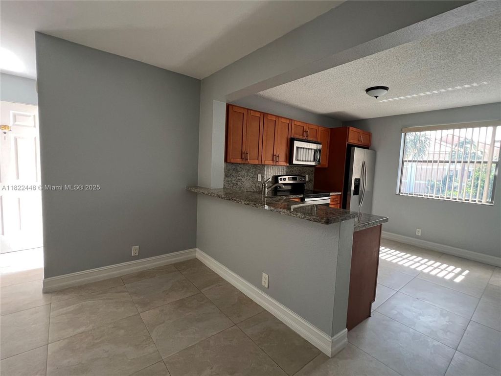 Photo of 5801 Riverside Dr #201B3, Coral Springs, FL 33067 (MLS # A11822446)