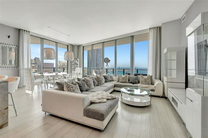 $400K PRICE REDUCTION!
Experience elevated living in this spacious northeast corner penthouse offering breathtaking panoramic views of Biscayne Bay, Key Biscayne, Miami Beach, and the dazzling Brickell skyline. Enjoy spectacular city lights by night from a prime vantage point high above it all. This residence features 3 bedrooms with ensuite baths, a den/office, and a guest powder room. Soaring high-volume ceilings and a generous wraparound balcony create an open, airy atmosphere, with multiple access points through high-impact sliding glass doors. The expansive primary suite includes a luxurious bathroom with separate soaking tub, oversized shower, dual vanities, and a walk-in closet. The home is equipped with flat-screen TVs throughout, Bose surround sound, and motorized solar and blackout shades for ultimate comfort and convenience.  Additional highlights include two assigned parking spaces and high-speed internet included. Residents enjoy exclusive access to Dua Miami’s luxury amenities, including a spa and residents-only rooftop pool.