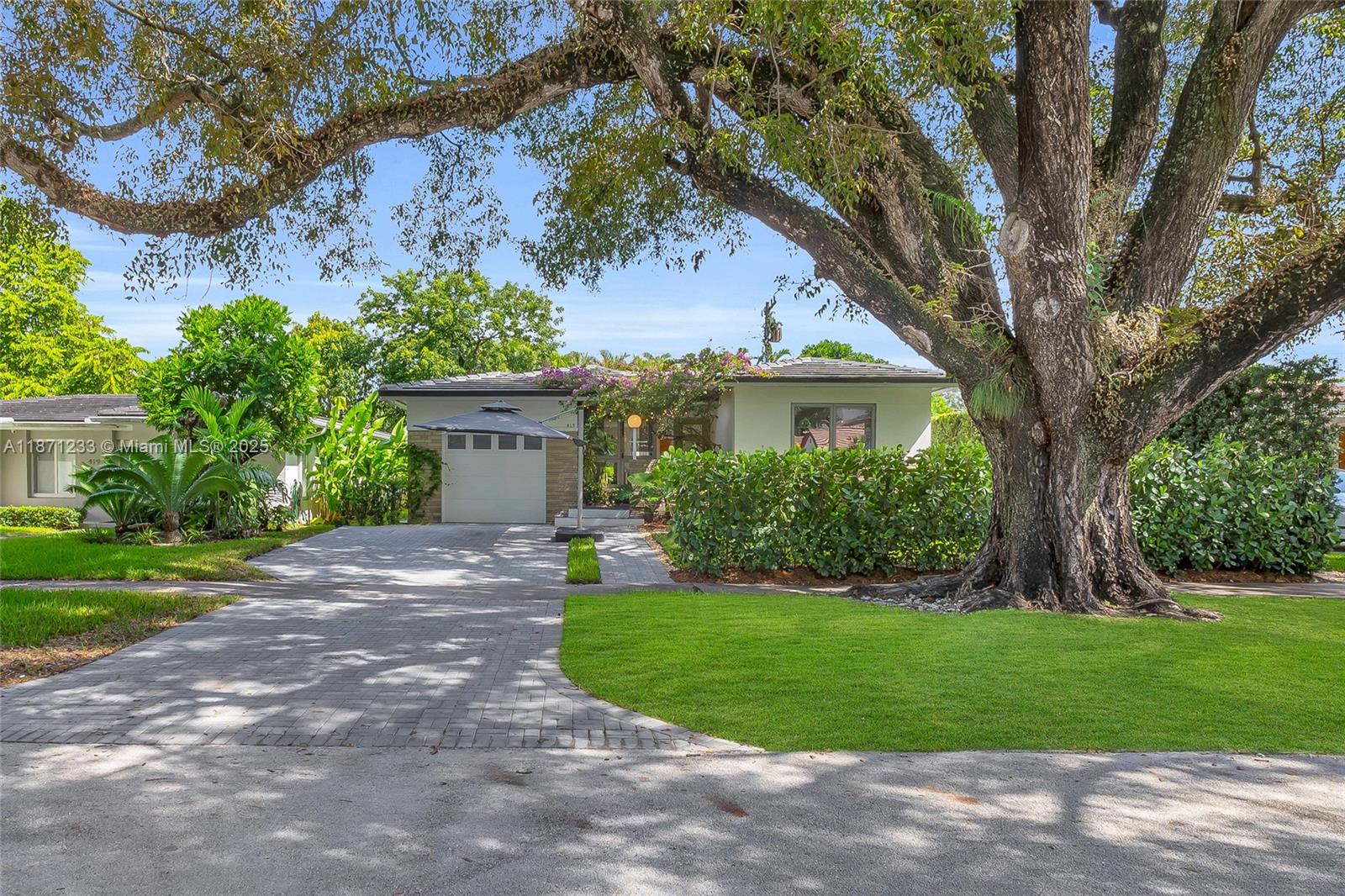 Completely turn-key Gables pool home, walking distance to Merrick, CG Youth Center, Library & more. Bursting with color & creativity, this unique residence blends character with modern comfort. Nestled on a lushly landscaped lot with mature trees, this mid century gem boasts an ideal split bedroom floor plan & outdoor living area with a new pool, turf/natural grass and a private lounge area. A designer kitchen anchors the home, opening to the dining, living & window lined family room which is bathed in natural light. All major upgrades are completed: 2 year-old impact resistant windows & cement tile roof. All new plumbing, updated electrical, new paver driveway & 1-car garage w/ extra loft storage. Gables lifestyle at its finest: a thoughtfully upgraded home w/ easy access to everything!