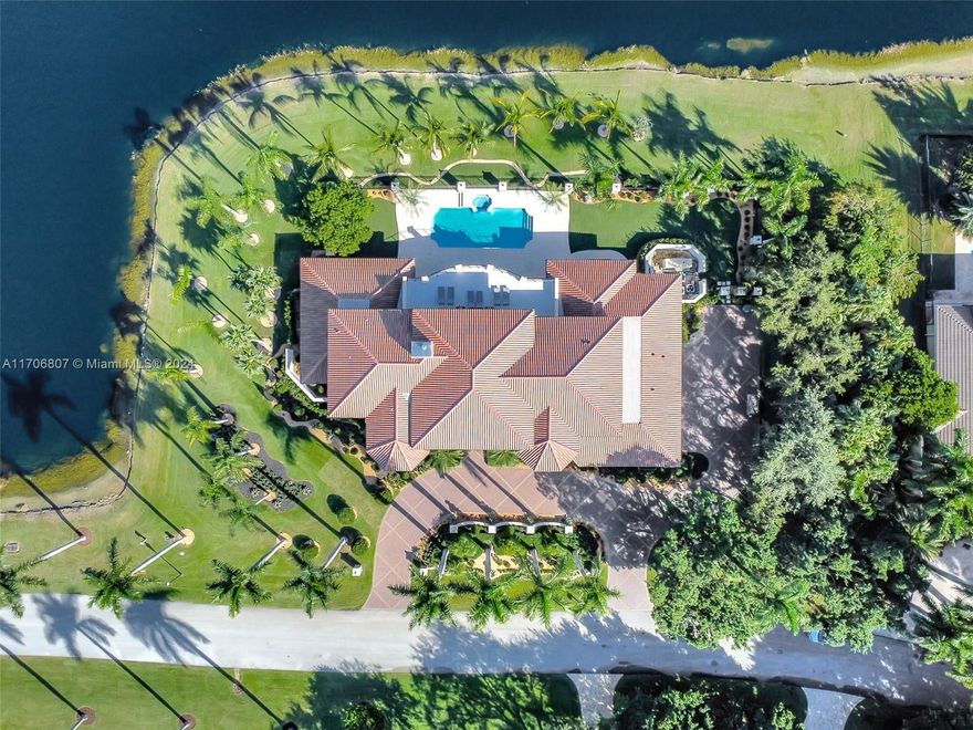Discover this exquisite two-story mansion with an in-ground pool, spa, 4-car garage, and over an acre of landscaped grounds.  

The 5-bedroom, 6.5-bath home boasts a gut-renovated first floor blending modern design with timeless Weston elegance. A grand entry hall features soaring ceilings, a fireplace, and a striking chandelier. The chef’s kitchen showcases a waterfall island, custom cabinetry, quartzite finishes, and high-end Miele appliances.  

The primary suite offers serene water views, a spa-like bathroom, and a massive walk-in closet. Spacious secondary bedrooms provide comfort and privacy.  

Additional highlights include a dining patio, impact windows, an elevator, generator, office, playroom, and marble-adorned laundry room.