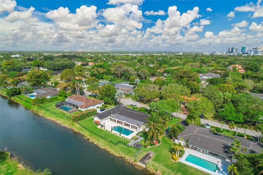 Rare Waterfront 5-Bed, 3-Bath Home with indoor laundry room and 2 car garage in Pinecrest! 
This beautiful home offers a split floor plan, nearly 3,000 SF of living space, and updated windows, doors, plumbing, and more. Located on a quiet street in a charming Pinecrest neighborhood, features include a remodeled backyard pool oasis, refinished wood floors, new AC units, new gutters, wired-in speakers, Nest thermostats and doorbell, smart switch remote lighting, and security cameras.  Enjoy a large primary bedroom, steam shower and jacuzzi.  Additional features include a kitchen wine cooler, cabana bath, sprinkler system, mosquito misting system, and a fully fenced backyard with access to the navigable C-100 canal.  Minutes from top schools, parks, shopping, and dining.  Great location!