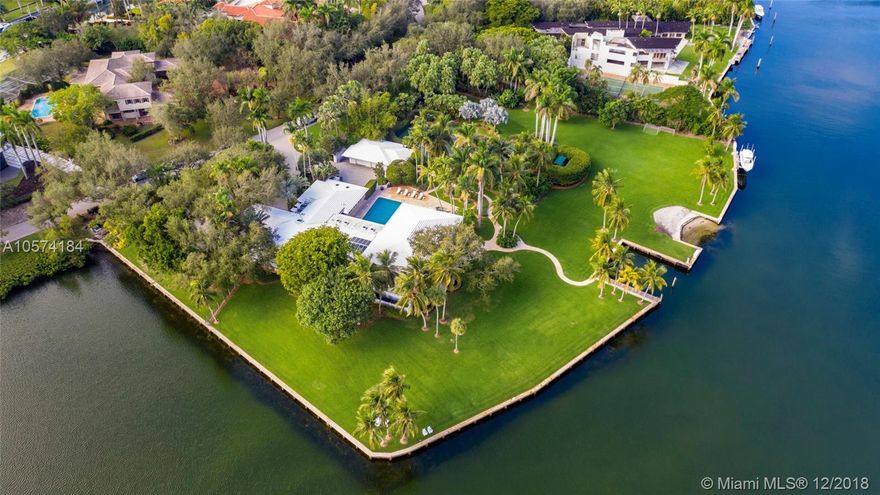 A once in a lifetime opportunity to purchase one of the largest parcels of land situated within the secure gates of Gables Estates.  The property is over 3 acres with 750 feet of water frontage on a wide water basin with endless unobstructed views leading to the bay. This magnificent residence offers limitless areas for entertaining with infinite water views, lush gardens, a pool, grandfathered in tennis court and private beach. Room for up to 150&#x2019; yacht.