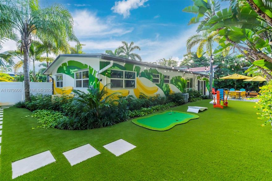 Resort-style pool home on an oversized 11,000+ sq ft corner lot in one of the hottest areas of Wilton Manors. Surrounded by lush landscaping and designed for privacy, this 4 bedroom, 3 bath residence features impact windows throughout, filling the open living spaces with natural light and tropical views. The updated kitchen and modern baths offer stylish comfort, while two ensuite bedrooms create ideal flexibility for guests, multigenerational living, or strong rental income potential. The expansive primary suite sits in its own private wing with a dedicated AC and opens directly to a patio and lagoon-style pool, creating the ultimate indoor-outdoor retreat. The backyard is built for entertaining with new turf and a mini golf area, delivering a true resort-style setting with minimal maintenance. Additional highlights include a 2 car garage, two separate driveways, new vinyl fencing, upgraded electrical and insulation, and a full house generator for peace of mind. Minutes from Wilton Drive, Las Olas, beaches, I-95, and Fort Lauderdale Airport, this property is ideal as a primary residence, vacation home, or high-demand Airbnb investment opportunity in one of South Florida’s most sought-after destinations.