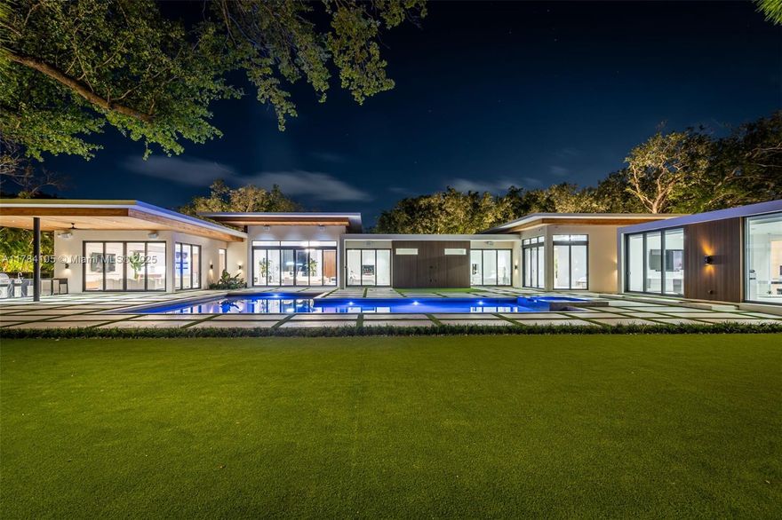 With 8,293 total square feet of solid concrete construction (5,349 under A/C), the residence features 6 bedrooms and 6.5 bathrooms, including a fully integrated 1-bedroom, 1-bathroom guest suite with dual walk-in closets. Enter through an impressive 11-foot hurricane-rated Mahogany pivot door into interiors defined by soaring ceilings, impact windows and doors, abundant natural light, and exceptional craftsmanship. The chef’s kitchen is outfitted with sleek, high-end Italian cabinetry, quartz countertops, and premium built-in appliances. All bedrooms are ensuite with views and direct access to the pool or outdoor areas. The primary suite includes a theater-grade 4K projector and oversized screen for an immersive in-home cinema experience. Fully automated smart home.