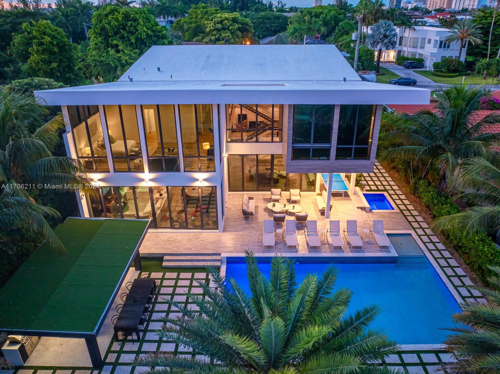 Welcome to your dream home in a prestigious gated community! This stunning 7-bedroom, 7-bathroom residence boasts a double high ceiling that enhances the spaciousness of the living areas. The large gourmet kitchen flows seamlessly into a cozy family room, perfect for entertaining. Step outside to discover a full outdoor kitchen, ideal for gatherings by the luxurious pool, complete with a refreshing cold plunge for relaxation. The large master bedroom offers a private retreat, while the nanny quarters provide convenience. An elevator serves all levels of the home. Security and entertainment are top-notch with a fully automated system featuring 12 cameras and speakers throughout. Plus, enjoy quick access to your jet ski with a dedicated dock lift. This property is a haven for luxury living!