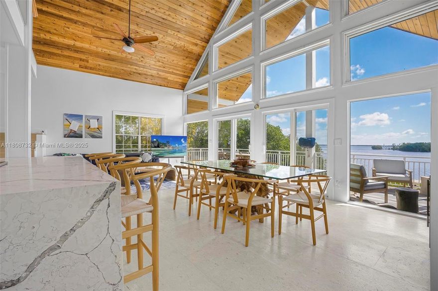 Stunning bayfront living in Key Largo’s sought-after Buccaneer Point! This 3BD/2.5BA home boasts breathtaking open water views with direct ocean access via the bay—perfect for boaters. The main living area is on the 2nd floor, featuring soaring wood-beamed ceilings, a modern kitchen with quartz countertops, and light-filled spaces with panoramic water views. The large primary suite on the 3rd level includes a spa-like bath and a private balcony. The roof is less than one year old.Downstairs, enjoy a spacious garage and an impressive bar/lounge area ideal for entertaining. Enjoy outdoor living with parking for multiple vehicles, RVs, or trailers, space for a pool, and a wood dock with a boat slip offering direct bay access. No HOA! Don’t miss this opportunity—check it out now.