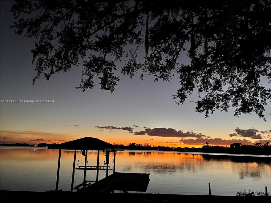 This stunning lakefront home offer amazing sunset views and white sandy beach bottom, perfect for your waterfront lifestyle. This tasteful renovated home on Lake Grassy feature three bedroom and two bathroom, a farmhouse kitchen style with stainless steel appliance and granite tops is a rustic modern concept; new ac, water heater, flooring, freshly paint inside and outside, this home is an idyllic retreat for those seeking tranquility and modern comforts. The two sets of glass sliding doors overlook the peaceful water views that lead to the screened back porch. Enjoy morning breakfast, lunches, or sunset dinner on the screened and covered by the back patio. Bring your boat and use the lift this lake house offer for the jet’s ski to fully embrace the watery sport the lake has to offer