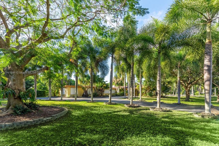 This 6,085 Sq. Ft. estate with 6 bedrooms and 5 bathrooms was designed to offer comfort and tranquility on a nearly two-acre lot with lush gardens and beautiful trees. Custom wood built-ins, marble fireplace and French doors   highlight a spacious floor plan that blends indoor and outdoor living. The generously proportioned kitchen, with stainless steel appliances, custom cabinets, breakfast area and two islands, flows into the family room, pool area and wood deck. Main suite comes with a luxurious walk-in closet, spacious and comfortable bathroom, and additional walk-in closet. Highlights include custom pool, tennis court, 3-car garage and full house generator. Located on corner lot with additional entrance on 62nd Avenue.