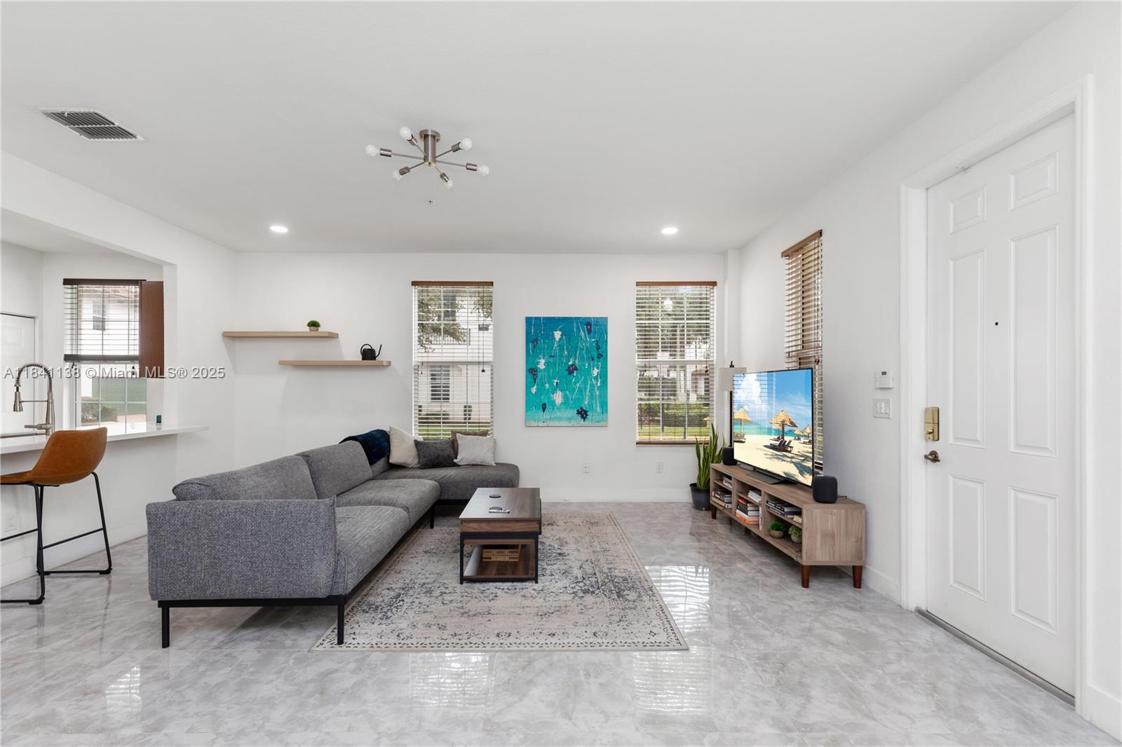 Gorgeous and recently updated modern corner town home. Stunning porcelain tiles, quarts countertops, and open layout downstairs. Come in from the courtyard in front or your spacious 2 car garage. This 3 bedroom 2 and half bath also has a loft/office area upstairs. Full size washer and dryer, new vinyl flooring upstairs. A primary bedroom with a large balcony, 2 spacious separate closets, and dual vanity primary bathroom. Tons of natural light really make this unit standout. Impact windows throughout for added security and quiet. Lake is right outside your door for nice walks by the water. Low hoa with community pool and gym, includes internet and cable. Great location for a commute as turnpike and I75 are not far.