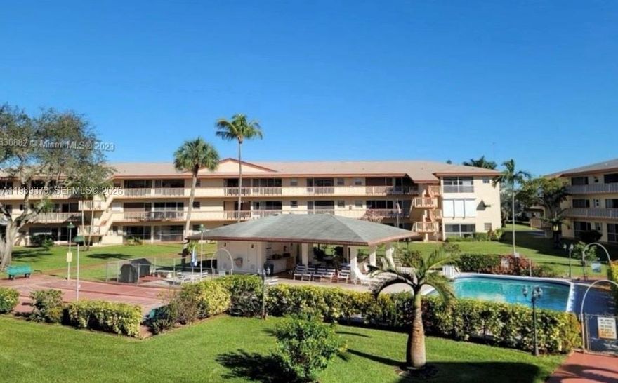 Beautiful 1 bed / 1 bath condo in the desirable Beverly Hills 55+ gated community, offering a perfect blend of comfort and convenience. This freshly painted, light-filled unit features neutral tile flooring throughout, an updated bathroom, ceiling fans, custom blinds, and a brand-new A/C for peace of mind. Unwind on your spacious screened-in porch with tranquil views of the pool and lush palm trees. Residents enjoy resort-style amenities including a clubhouse with library, fitness center, billiards room, full kitchen, and social/dining areas, plus a pool, BBQ area, petanque, bocce, shuffleboard, and courtesy bus service. Monthly HOA covers landscaping, water/sewer, trash, building insurance, and exterior maintenance—making for truly low-maintenance living. Ideally located just minutes from major highways, top dining and shopping, airports, casinos, and South Florida’s beautiful beaches, this is an exceptional opportunity you don’t want to miss.