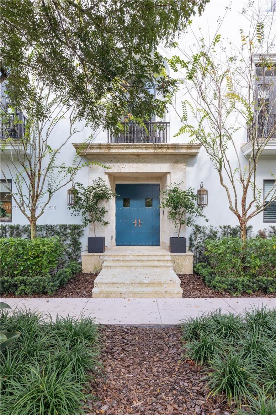 Located in Coral Gables on a picturesque tree-lined street, this refined corner residence reflects Spanish-Colonial brownstone architecture. Filled with natural light, the home offers expansive loggias that create seamless indoor-outdoor living. The three-story layout features approximately 4,250 square feet of interior space, highlighted by a dramatic skylit staircase, twelve-foot ceilings, bespoke millwork, curated designer wall coverings, and Portola specialty finishes. Additional features include a marble-clad chef’s kitchen with Wolf and Sub-Zero appliances, butler's pantry, Waterworks fixtures in all bathrooms, custom closets, a fully integrated Crestron smart-home system, climate-controlled wine room with custom racking, a private elevator, fully appointed summer kitchen within the loggia, two laundry rooms, and a rare four-car garage. Ideally located, offering the rare balance of walkable village charm, and the refined, enduring lifestyle that defines Coral Gables