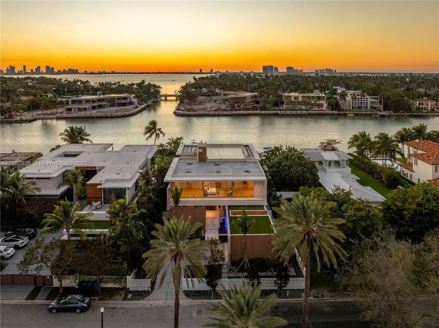 Pinnacle of luxury at 6494 Allison Road, a waterfront residence on exclusive gated Allison Island. This newly finished home features 6 bedrooms and 8.5 bathrooms within 8,024 sqft of elegant living space. The primary suite is sublime, with private sitting room, dual baths, and spacious closet space. MiaCucina kitchen is designed for culinary excellence, featuring premium Wolf and Subzero appliances. With Control 4 home automation, modern living is effortlessly integrated. Enjoy the convenience of a 2-car garage with lifts, an expansive rooftop, and gym with sauna and steam rooms. The outdoor area features an infinity-edge pool, a summer kitchen, and a 40k lb. boat lift with two waverunner lifts. Embrace a lifestyle of sophistication, where impeccable craftsmanship and luxury meet.