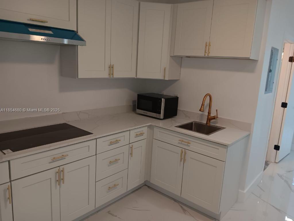 Discover this fully furnished and equipped apartment, ready for you to move in. Located at Mile Marker 98 in Tavernier, this unit offers an unbeatable location with direct exposure on the Overseas Highway. The building recently underwent over $100,000 in furnitures, including brand-new appliances and top on the line equipment in each unit. The building is a hub of activity, with popular businesses like a hair and nail salon, a pizzeria, and a doctor's office. A food truck and ice cream shop are also coming soon, attracting plenty of foot and car traffic.