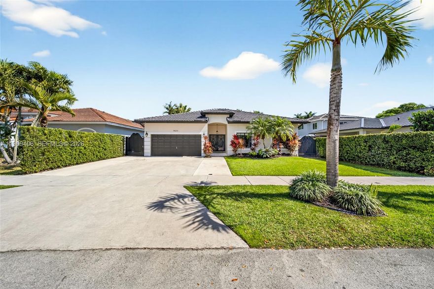 Welcome to this beautifully updated 4-bedroom, 2-bathroom home, located on a 6,008 square foot lot in an upscale West Kendall neighborhood. From the moment you step inside, you’ll appreciate the high ceilings and bright, open layout that create an inviting and spacious feel. The updated kitchen features stainless steel appliances, modern finishes, and ample counter space. Tile flooring runs throughout the main living areas, complemented by elegant wood-like flooring in the bedrooms. The primary suite is a true retreat, complete with a walk-in closet, a private bathroom suite, and French doors that open directly to the backyard oasis. Step outside to your own private paradise featuring a sparkling pool with a top-of-the-line Pentair heater. The tiki hut and fully equipped outdoor kitchen make this home an entertainer’s dream — perfect for hosting gatherings or relaxing weekends at home. With generous indoor and outdoor living spaces, thoughtful upgrades, and a prime location in West Kendall, this home offers the perfect blend of comfort, style, and South Florida living.