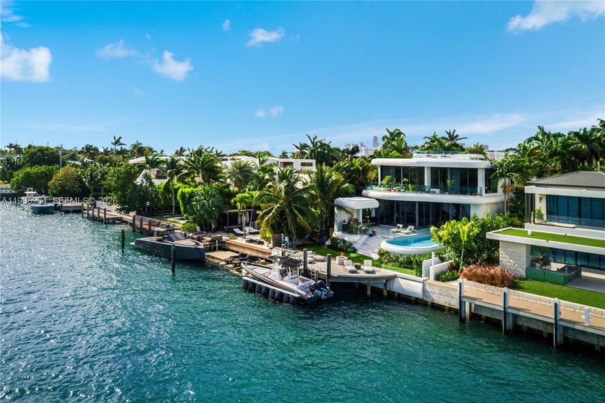 Built in 2018 & designed by DOMO Architecture, this extraordinary waterfront estate stands as the tallest residence on Dilido Island, offering architectural distinction, privacy & uncompromising luxury. Conceived for grand-scale entertaining, the home features executive-level security & soaring 12 foot ceilings with a fully integrated smart-home system. An exceptional use of luxurious marble throughout the interior & exterior creates a timeless, gallery-like elegance. The state-of-the-art kitchen, finished in striking Calacatta Gold marble & equipped with Wolf, Miele, & Sub-Zero appliances, anchors the home as a natural gathering space. Living areas flow seamlessly outdoors, embracing indoor-outdoor living with a resort-style pool, Jacuzzi, cabana, & a custom extra-large rounded Ipe dock, ideal for waterfront entertaining. Private bedroom suites embody modern luxury, featuring warm chevron oak floors, floor-to-ceiling sheer drapery, refined marble details, & Waterworks faucets and shower fixtures throughout. A dedicated cinema room with an 8K 125-inch projection screen & THX surround sound delivers a true private theater experience. Crowning the residence is a spectacular rooftop retreat with 360-degree water views of Downtown Miami and Miami Beach, complete with an award winning fully edible rooftop garden/farm. Additional features include a showroom garage (lift capable) & mature fruit & vegetable trees, completing this one-of-a-kind waterfront offering.