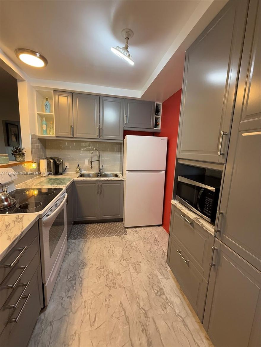 **JUST REDUCED** BEAUTIFULLY TURN-KEY FURNISHED 2 bedroom condo located in the 55+ gated community of Century Village. Open layout, kitchen wall has been opened up and is great for hosting. Additional built-ins, lots of storage space. All windows are Hurricane Impact that were done in 2022 and AC is about 2 years old. Both bedrooms are spacious and the primary one has a screened in Florida room with impact sliding door. Unit is located on the second floor, no upstair neighbor. No carpet found throughout the unit. Rentals are allowed after 2 years of ownership. Century Village offers many amenities such as security, pools, clubhouse, activities, gym and much more!