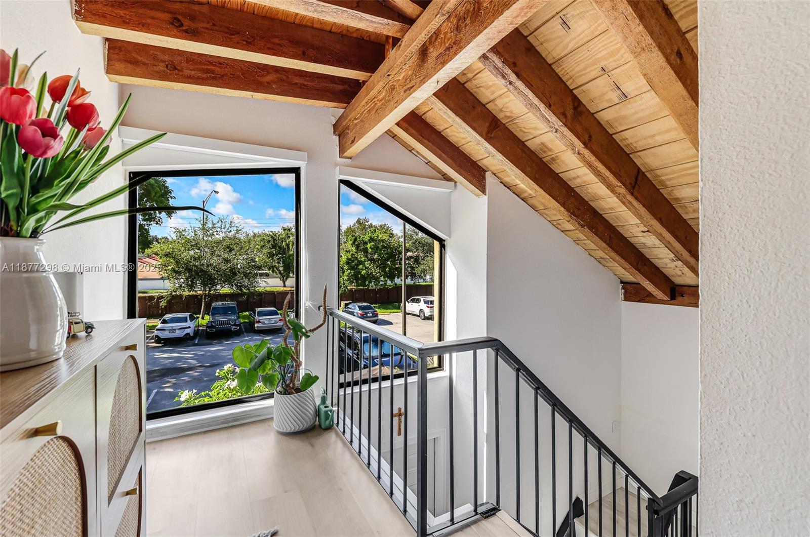 Remodeled 3BR/2BA townhome-condo + den/office. Features include vaulted ceilings with exposed wood beams, updated laminate wood flooring, remodeled kitchen & baths, high-impact windows/doors, and zebra blinds. HOA covers internet, basic cable, water, insurance & roof repairs. Community offers one of the largest pools in Miami, a children's playground area, tennis courts & more. Move-in ready!