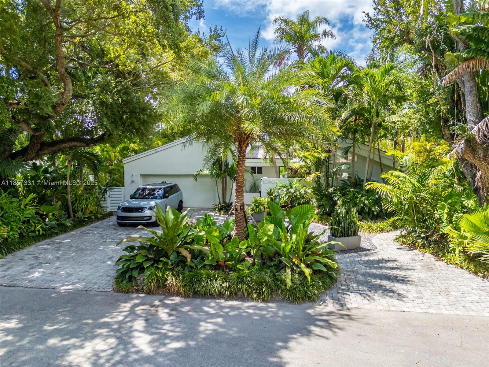 Set amid a lush canopy tree hammock, this Miami Shores gem offers 3,227 sq. ft. of bright, open-concept living on a 9,375 sq. ft. lot. Designed for the ultimate entertainer, it features a heated pool, open-air atrium, and a full outdoor kitchen with fridge and barbecue, creating flawless indoor-outdoor flow. Highlights include custom closets, a luxe primary suite with steam shower and walk-in, plus new roof, electrical, plumbing, and designer lighting. The incredible landscaping with mature oak trees creates a private backyard oasis. Additional perks include zoned cooling with 2 AC units, a double car garage with new laundry, driveway parking for 5 cars, and potential to convert the garage into 500 sq. ft. of extra living space.