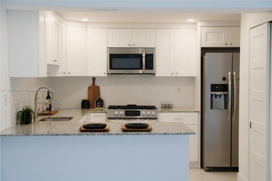 Light, bright & airy 3-bedroom 2-bathroom, one-story home with front and backyard, completely remodeled Granite countertops brand new gas stove, real wood shaker cabinets, and white porcelain subway tiled backsplash will make this kitchen a joy to cook in. The master bath is also completely remodeled with a double vanity featuring a quartz top and a walk-in shower with porcelain tiles and glass shower enclosures. New beautiful, whitewashed laminate flooring makes the open spaces seem even larger.