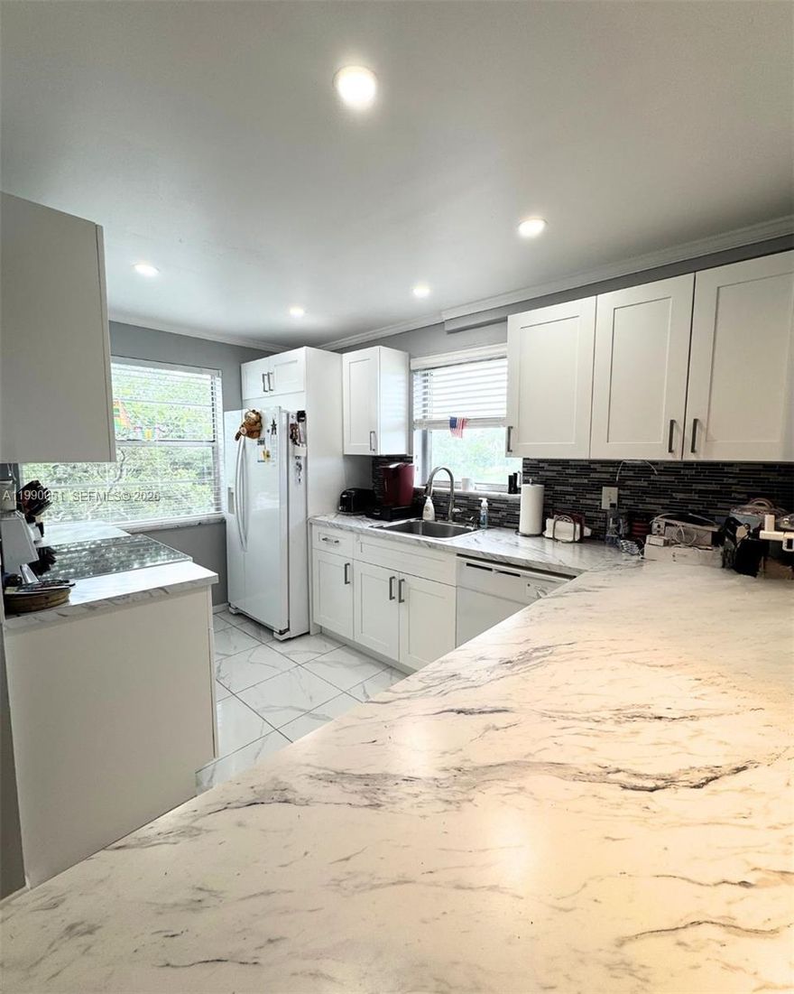 Nestled in the lush, gated Las Vistas community, this corner unit is completely remodeled 2-bedroom, 2-bathroom retreat that offers style, comfort and peace of mind. Has a bright, open-concept modern kitchen. Both bedrooms are generously sized the primary suite boasts a large walk-in closet and a spa-like en suite bathroom with frameless glass shower and dual vanity, while the second bedroom sits steps from a full second bathroom finished with contemporary fixtures and stylish tile. Enjoy year-round comfort with central AC, and revel in the updated finishes Outside your front door, Las Vistas offers a sparkling pool, clubhouse, and fitness center. Located minutes from dining, shopping & Inverrary’s recreational amenities, this turnkey gem perfectly blends modern elegance & community living. Home Warranty will be transferrable. No Special Assessments.
