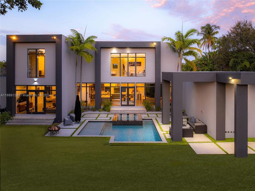 Welcome to Casa Oasis! This modern waterfront masterpiece offers spectacular golf course views and 146 feet of canal frontage with direct access to Biscayne Bay. Nestles in a cul-de-sac, 4,796 SQFT main house offers an open-concept design with formal living and dining, gourmet kitchen, family room, hobby room, and media center on the first floor. Upstairs, the master suite features a walk-in closet, private lounge, and en-suite bathroom, while two bedrooms shares a Jack-and-Jill bathroom. The detached guest house includes an additional bedroom, bathroom, and living space with water views. Outdoors, enjoy the pool, infinity Jacuzzi, waterfront dock with heavy duty boat lift, and floating dock. Next to Miami Shores Country Club with an 18-hole golf course, tennis, and top private schools