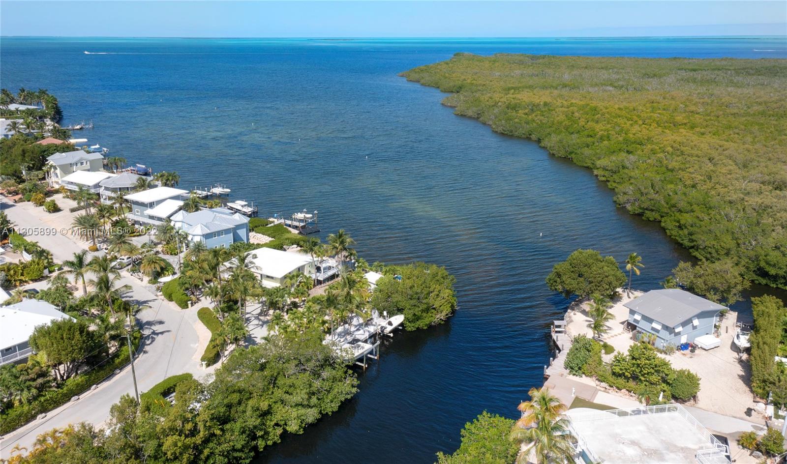 Glittering open bayfront views encapsulate this residence. Positioned on a 17,271 sq. ft. lot, this property has lush and manicured landscaping providing utmost privacy. Located in a desired neighborhood on Plantation Key, this open living home is drenched with views throughout and complete with two bedrooms and two bathrooms upstairs and one bedroom and one bathroom downstairs with a kitchenette. Features include 312 ft of water frontage, protected dockage, 2 boat lifts, an elevated jacuzzi tub with bay front views, room for an RV, space for a pool and outdoor kitchen, garage space, impact windows and doors, and an outdoor tiki. Come home to this old Florida-style residence that exemplifies Keys living.