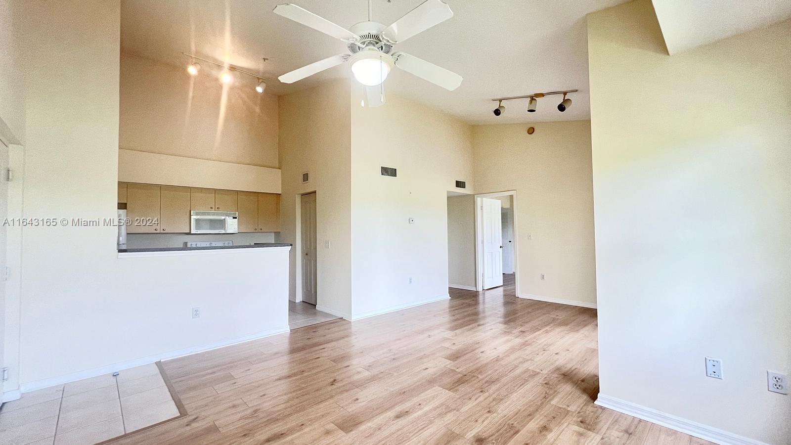 LAKE VIEWS, NEW FLOORS, VAULTED CEILINGS, 2022 AC!! Welcome to this bright and large one-bed, one-bath condo featuring high vaulted ceilings and an open balcony that offers breathtaking LAKE VIEWS and beautiful sunsets. The open-concept kitchen, paired with the newly installed wood laminate flooring and neutral color palette, creates a warm and inviting atmosphere. Recent upgrades include a new HVAC unit installed in 2023. Located in the desirable gated community of Emerald Isles, residents enjoy access to a variety of amenities including a swimming pool, tennis courts, exercise room, and basketball courts. Conveniently situated just 10 minutes from City Place and downtown, this condo offers an unbeatable location. Rent includes Hotwire basic cable, high-speed internet, and water/sewer.
