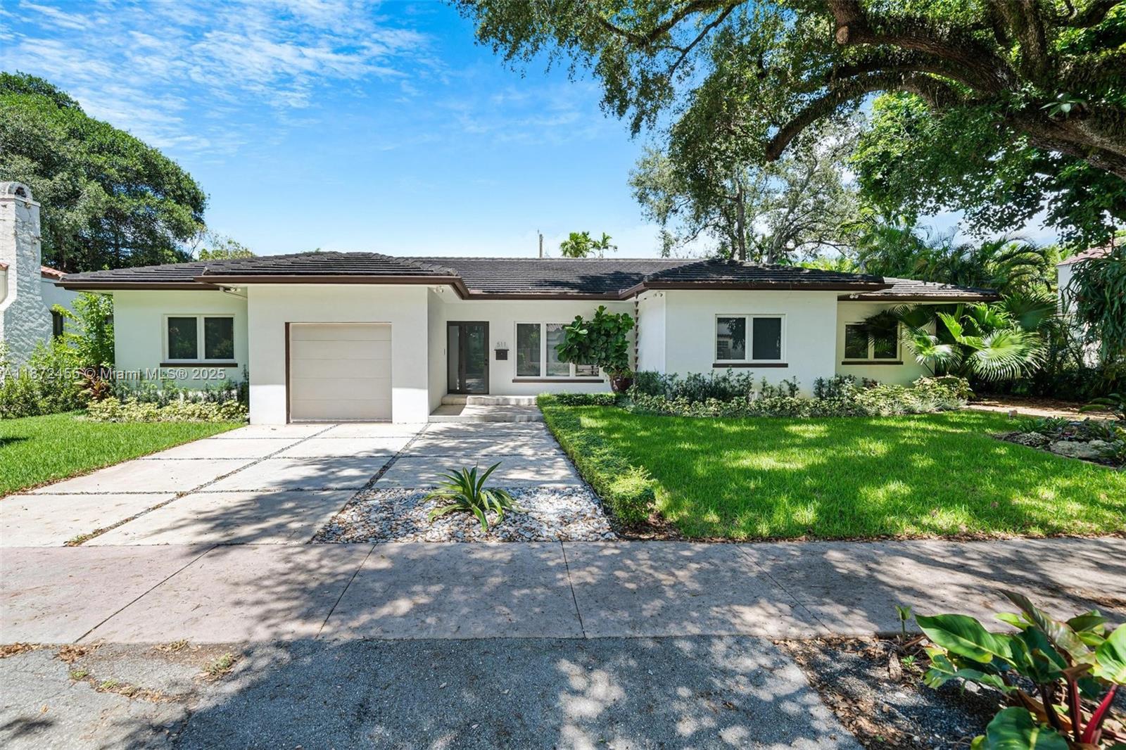 This beautifully renovated, one-story modern home in Coral Gables was fully updated in 2017 and features light-filled living and dining spaces that open to a sparkling heated pool and expansive outdoor entertaining area. The sleek kitchen boasts an island, Sub-Zero appliances, and ample storage, while the primary suite offers two custom walk-in closets, dual vanities, and additional storage closets in the bath, along with direct access to the patio. All other bedrooms are ensuite, and the home is complete with a one-car garage plus driveway parking. Situated near Miracle Mile, this home provides easy access to top dining, shopping, and the best of Coral Gables living.