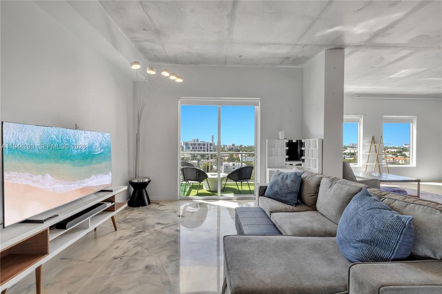 This South-facing NeoLofts residence brings the Miami skyline right into your living room. Step inside & you’re met with endless blue skies & city lights through oversized windows. With 13-foot ceilings, painted concrete floors & a spacious open unit, life here feels both grand & effortless. And when it’s time to step out, you’re just a stroll across the bridge from Casa Neos, Downtown Miami & the energy of Brickell & Wynwood. With a large, open, loft style space, you can treat this 2 bedroom unit as 1 bedroom plus an office. Amenities: pool, hot tub, fitness center, sauna, dog park, zen garden, tennis court. Please note: Monthly HOA: $1,161.59 Monthly Assessment: $449.63. Monthly total: $1,611.22.  Assessment can be paid off in March or April 2026 without interest; 1 assigned parking spot, 6 month rental minimum, 2 pets max per association, internet, water & trash included